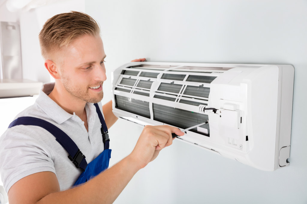 HVAC technician performing ductless air conditioning maintenance in Parker