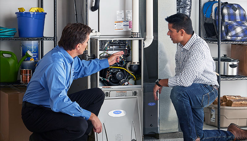 HVAC technician evaluating a furnace for repair or replacement in Parker