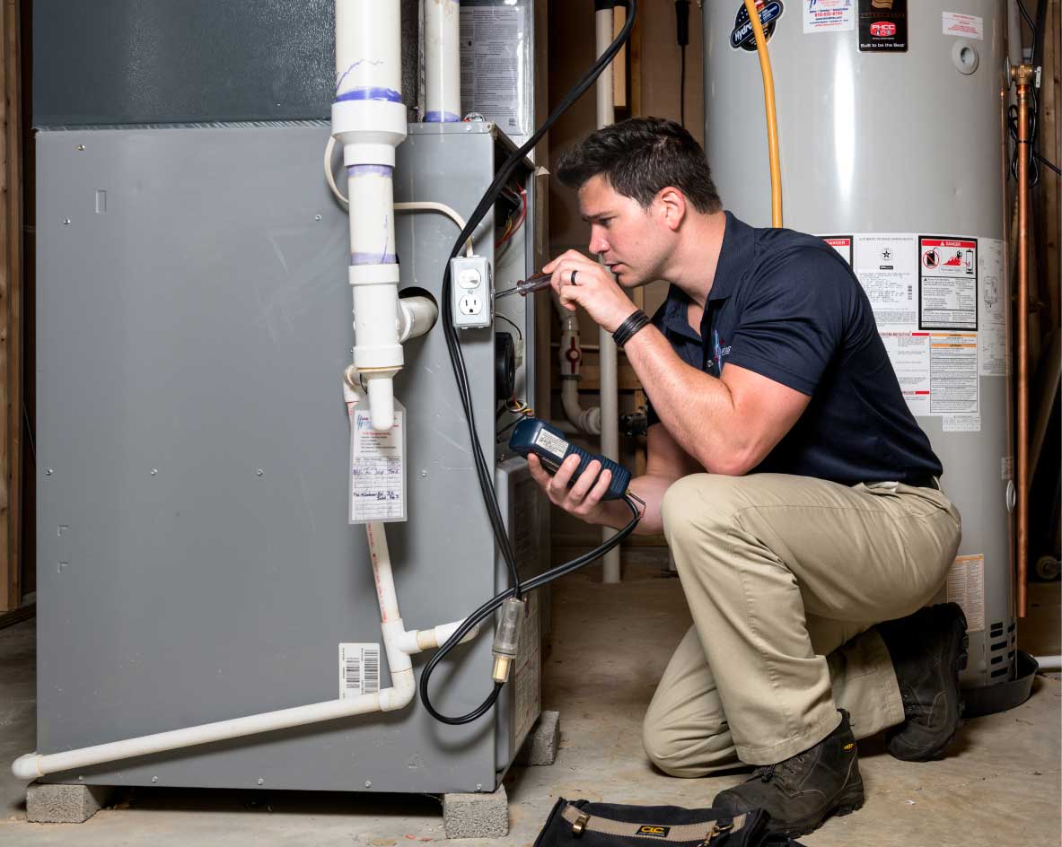 HVAC technician performing a furnace tune-up in Parker