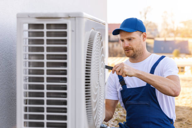 HVAC technician servicing an outdoor air conditioning unit in Parker