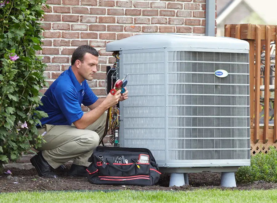 HVAC technician inspecting an outdoor air conditioning unit in Parker