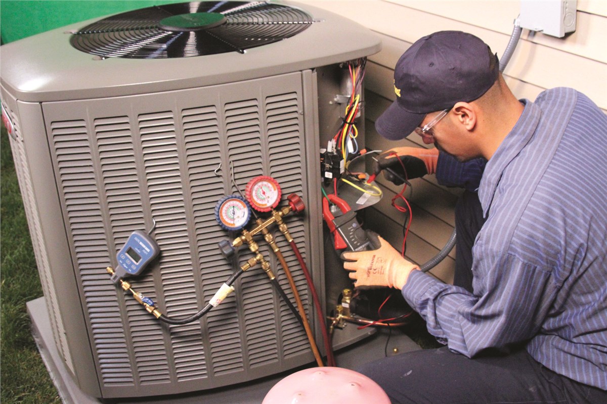 HVAC technician testing an outdoor air conditioning unit in Parker